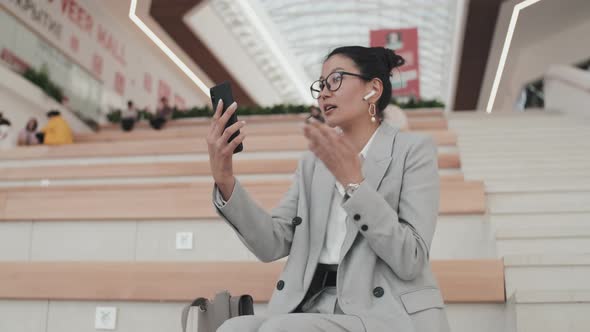 Asian Businesswoman Talking on Video Call in Mall