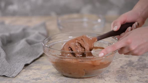 A Person Stirs Chocolate Batter for Baking Cake