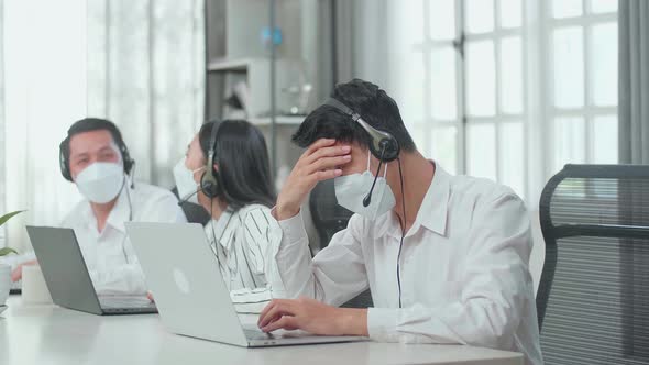 Man Call Centre Agents Wearing Mask And Headache Because His Colleagues Are Talking With Each Other