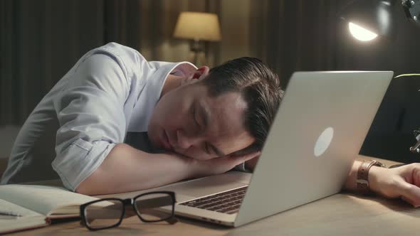 Asia Man Sleeping While Working From Home At Living Room At Night