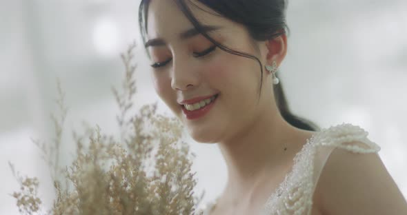 Slow Motion Smiling Beautiful Asian Bride In Wedding Dress With Flowers Bouquet.