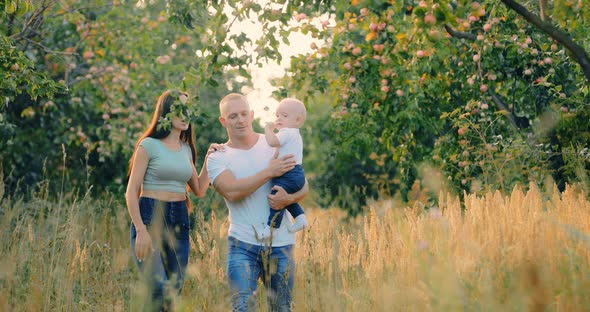 Happy Family Walking in the Woods