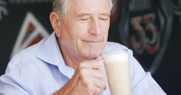 Senior Man Having Milkshake in Cafe 4k