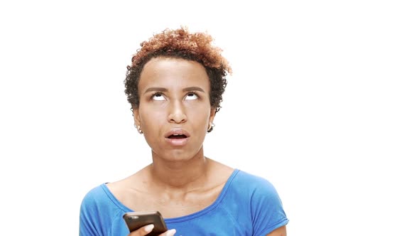 Displeased Young Beautiful African Girl Looking at Phone Over White Background