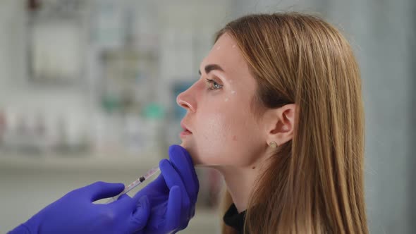 Side View Closeup Beautiful Woman Getting Beauty Filler Injection in Chin