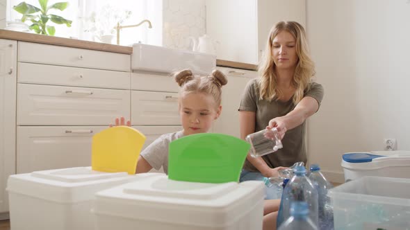 Video of girl and woman separating recycling material at home. Shot with RED helium camera in 8K