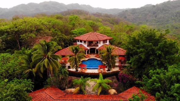 Aerial shot lowering camera view of a beautiful resort and spa in Tamarindo Costa Rica.