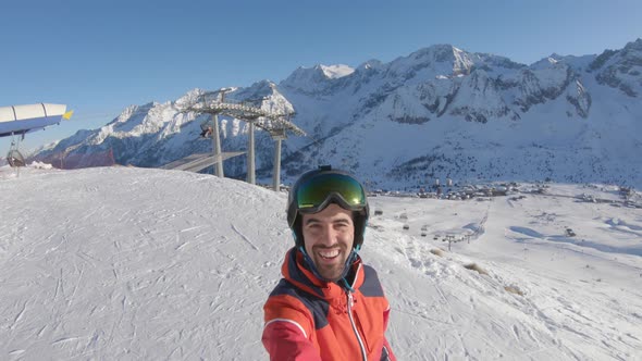 Man on top of snow slopes showing mountains view