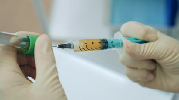 Close Up of a Syringe Getting Filled with Anesthetic