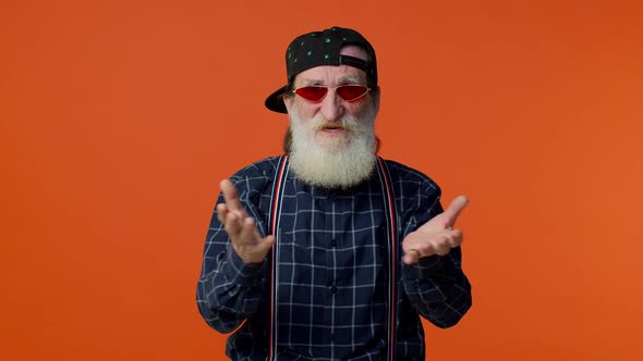Mature Old Bearded Grandfather in Sunglasses Showing Wasting or Throwing Money Around Hand Gesture