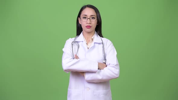 Young Beautiful Asian Woman Doctor Smiling with Arms Crossed