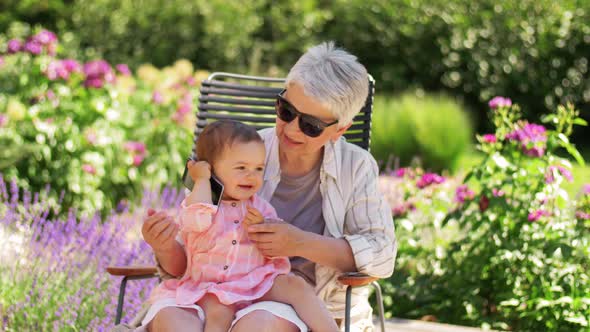 Grandmother and Baby Granddaughter with Smartphone