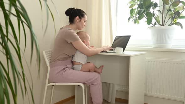 Young Mother Work Studying From Home with Laptop Computer During Quarantine Little Cute Toddler Baby