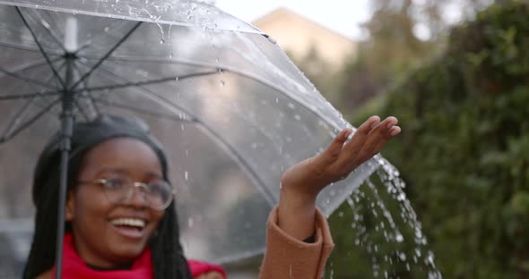 Black Girl with an Umbrella in the Middle of the Autumn Street