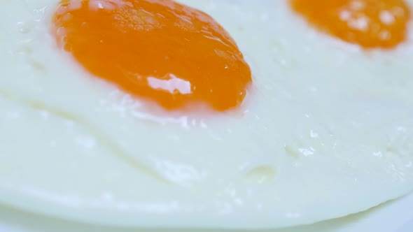 Egg yolk and white fried on oil for tasty breakfast 4K 2160p 30fps UltraHD food footage - Fresh hen 