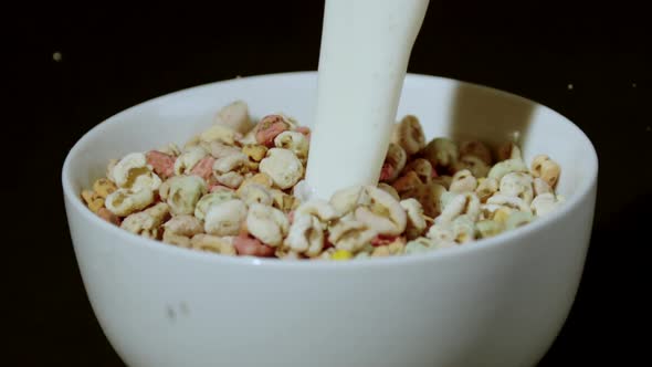 Milk being poured into bowl of puffed wheat cereals, Ultra Slow Motion