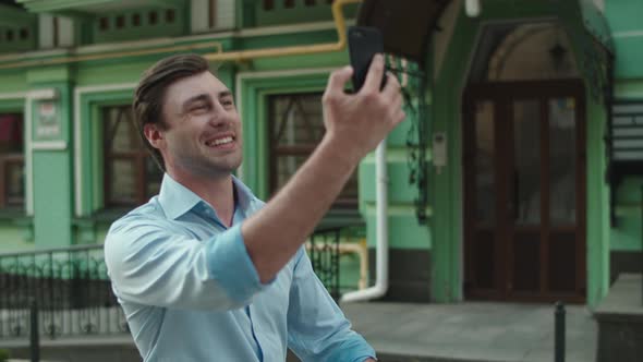 Closeup Businessman Walking with Phone at Street. Man Talking By Video Call