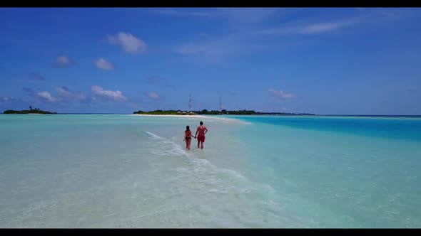 Man and woman sunbathing on beautiful bay beach voyage by blue ocean and bright sandy background of 