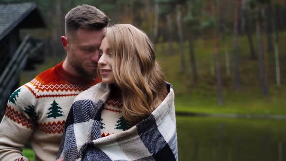 Young couple in love. Romantic couple standing close to each other in warm autumn day.