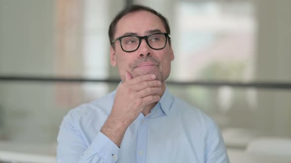 Portrait of Pensive Middle Aged Man Thinking