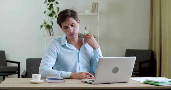 Attractive Tired Male Employee Holding Notebook in Hand Feels Uncomfortable Hot in Summer Weather