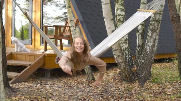 Beautiful Girl Having Fun in Hammock at Autumn Warm Day