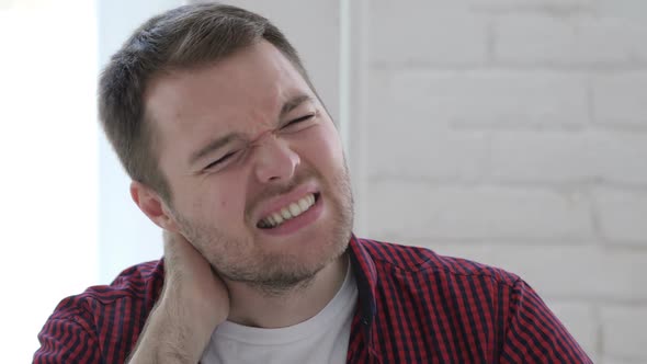 Tired Young Man Trying to Relax Body By Stretching