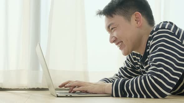 happiness peaceful smile asian male enjoy work from home quarantine  relax and positive work