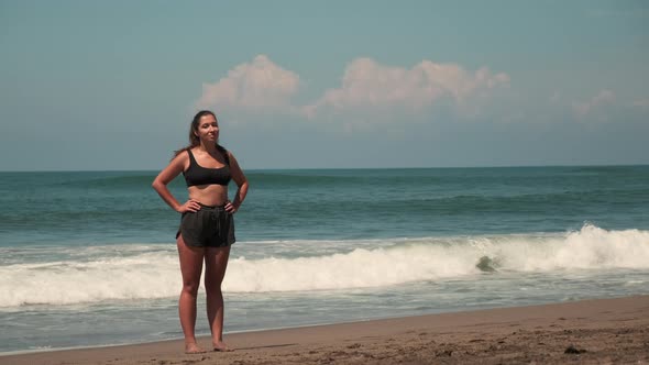 Attractive Female is Training at Sandy Ocean Shore