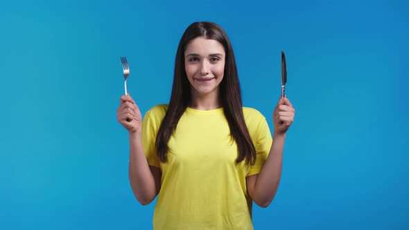 Portrait of Hungry Woman with Fork and Knife