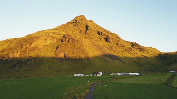 an aerial of a small village in iceland during sunrise