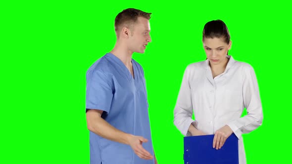 Young Medical Staff Talking Together. Doctor Scolds Intern. Green Screen