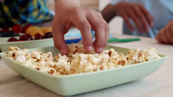 Child Hands Grabbing Popcorn
