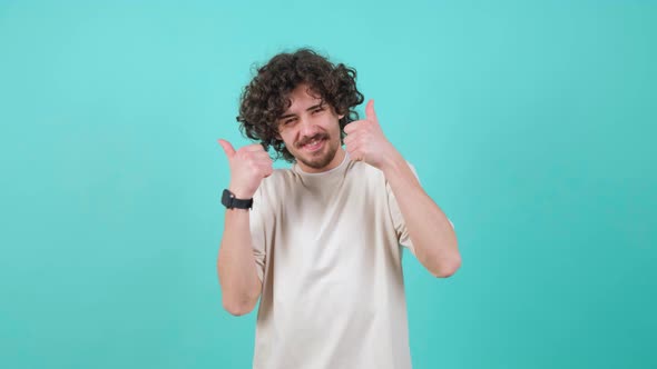 Satisfied Bearded Man with Curly Hair Doing Thumbs Up Gesture