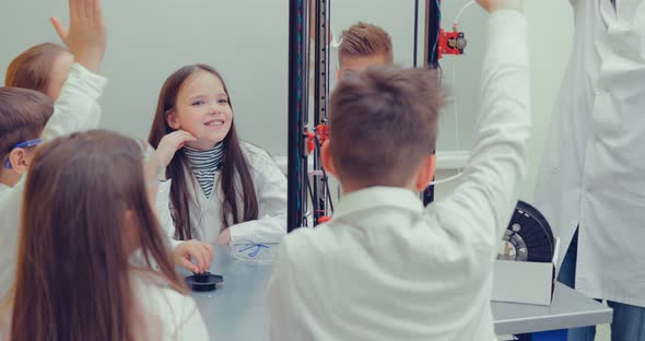 Schoolboy and Schoolgirls in the Classroom Creating Models for Project Using 3D Printer