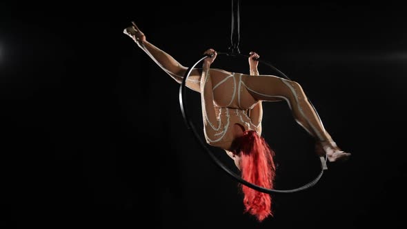 Wide Shot Slim Young Woman Spinning on Air Hoop in Upside Down Split