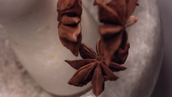 Granite Mortar and Star Anise Spice Species Falling in Slow Motion