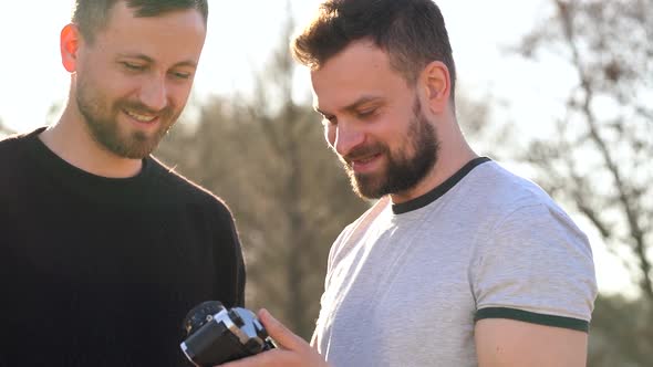 Young Gay Couple Taking Photo of Themself on a Film Camera in the Spring Evening