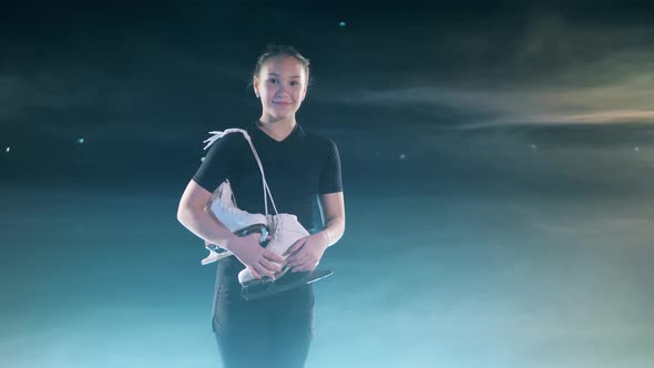 Young Female Skater is Smiling with the Skates Over Her Shoulder