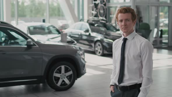 Young Car Salesman Posing in Dealership