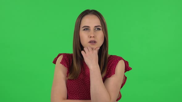 Portrait of Tender Girl in Red Dress Is Thinking About Something, and Then an Idea Coming To Her