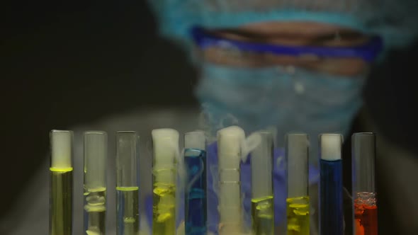 Researcher Adding Liquid in Test Tube With Chemical Substance Emitting Smoke