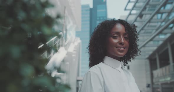 Young woman looks at the camera and smiles