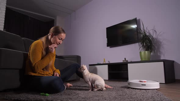 Joyful Woman Playing with Pet Instead of Cleaning