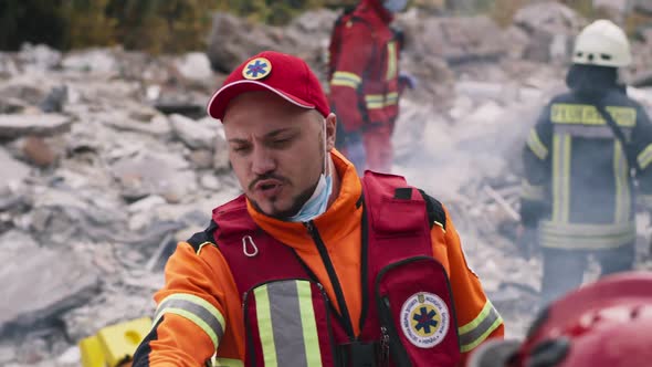 Paramedic Speaking with Colleagues After Earthquake