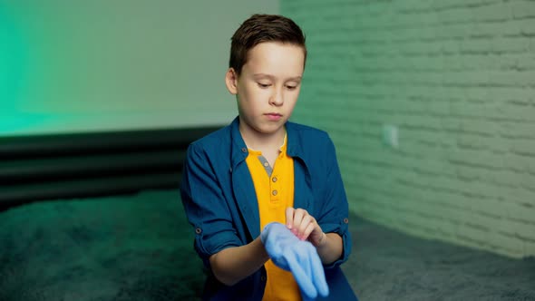 Boy puts on rubber gloves