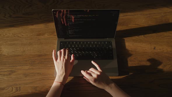 IT Woman Hands Typing and Reviewing Code on Laptop Indoors