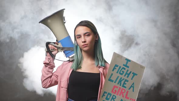 Young Female Feminist with Megaphone Promoting Feminism