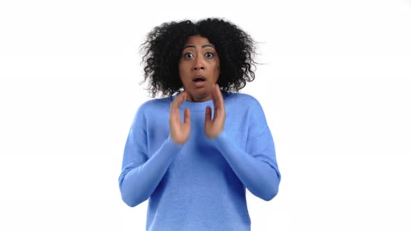 Portrait of African Unpleasantly Surprised and Shocked Girl on White Studio Background