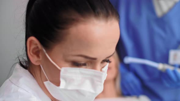 Female Dentist at Work in Dentist's Office